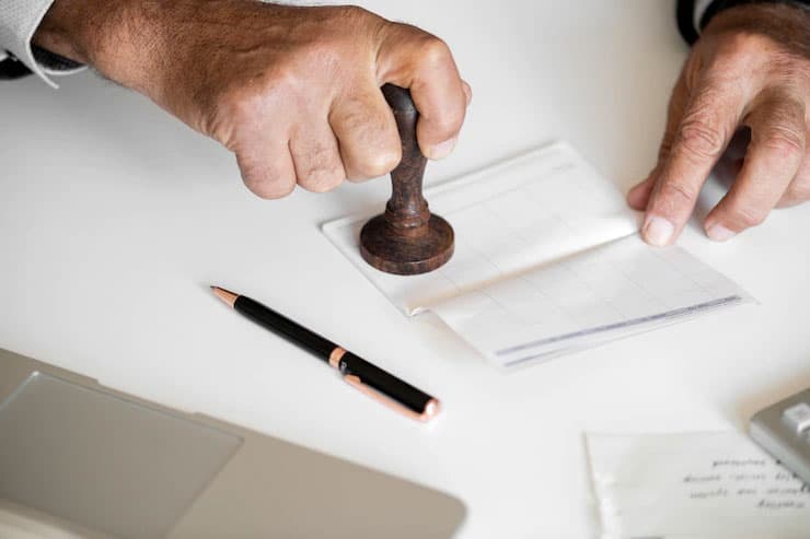 An officer stamping and attesting a certificate
